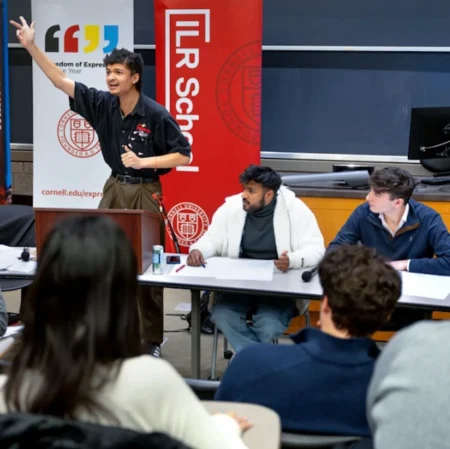 A group of students participate in a formal classroom debate